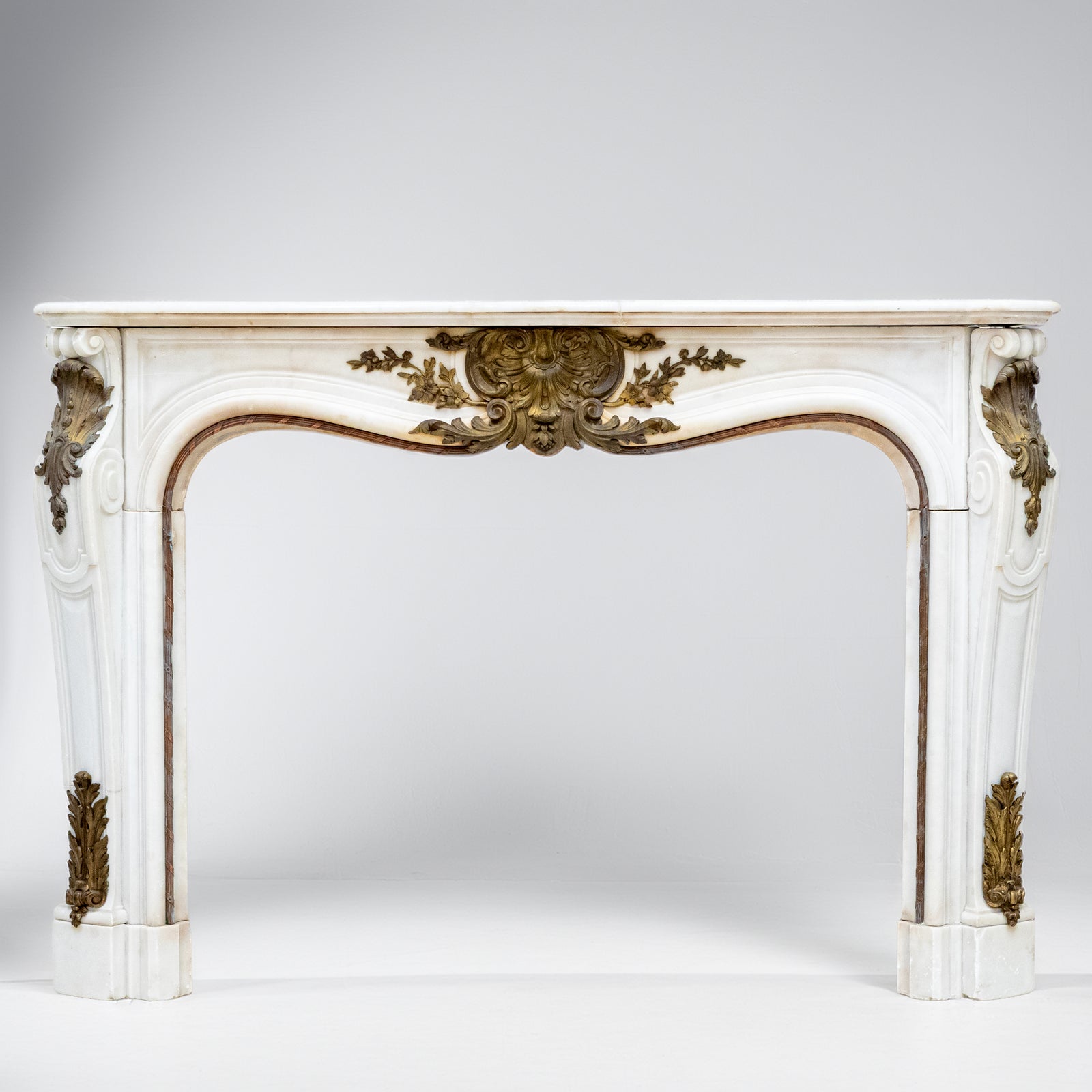 Antique French Louis XV Style Statuary Marble Fireplace with Brass Mounts | The Architectural Forum