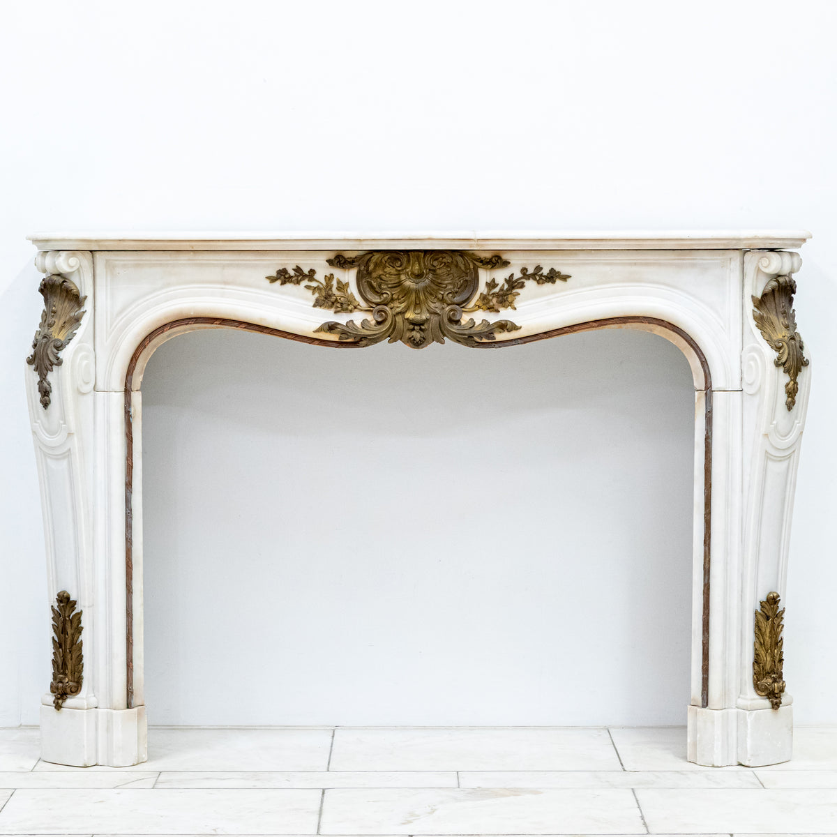 Antique French Louis XV Style Statuary Marble Fireplace with Brass Mounts | The Architectural Forum