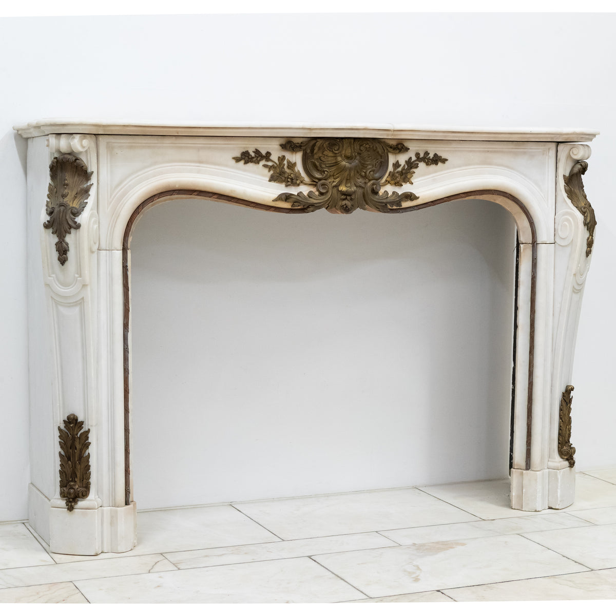 Antique French Louis XV Style Statuary Marble Fireplace with Brass Mounts | The Architectural Forum