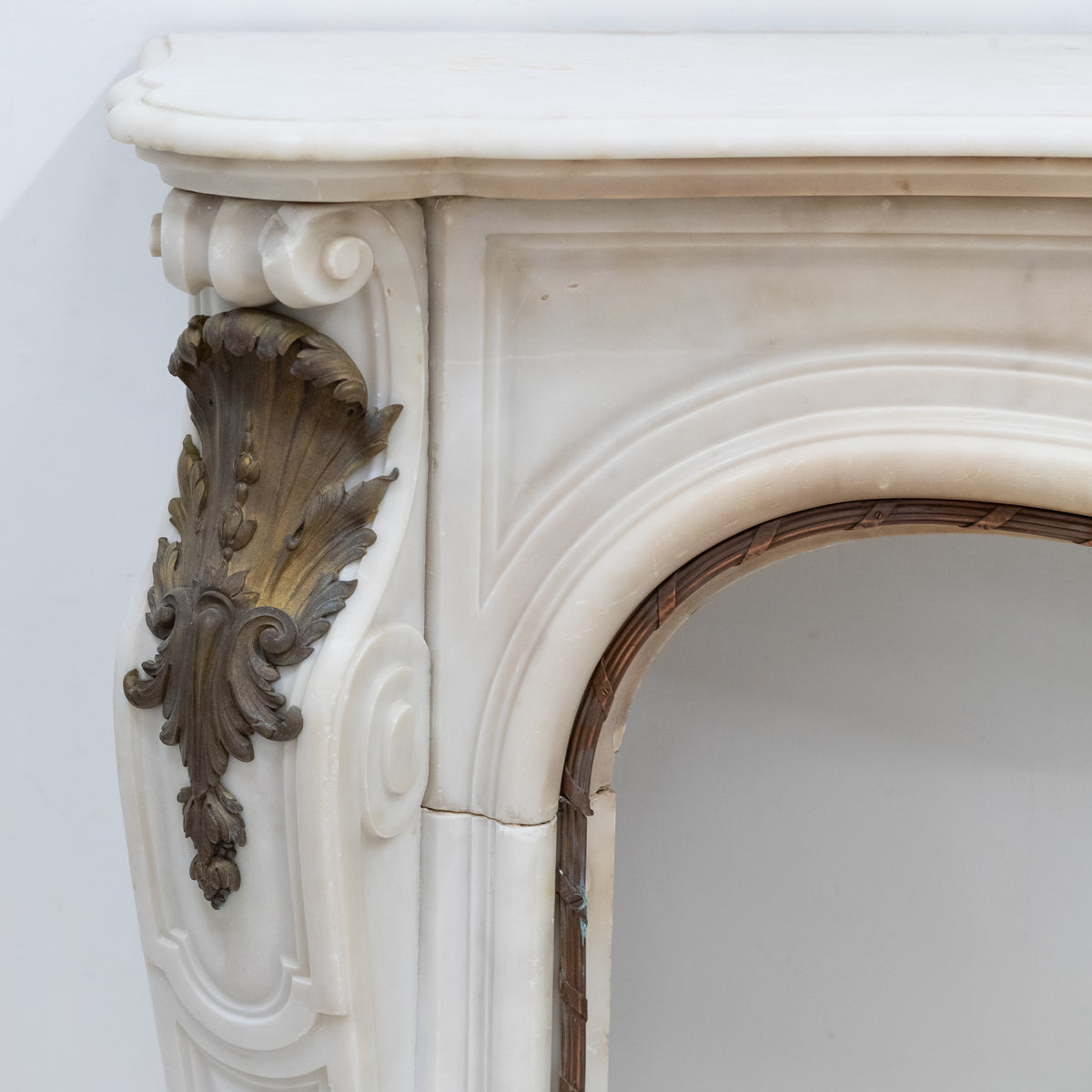 Antique French Louis XV Style Statuary Marble Fireplace with Brass Mounts | The Architectural Forum
