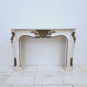 Antique French Louis XV Style Statuary Marble Fireplace with Brass Mounts | The Architectural Forum