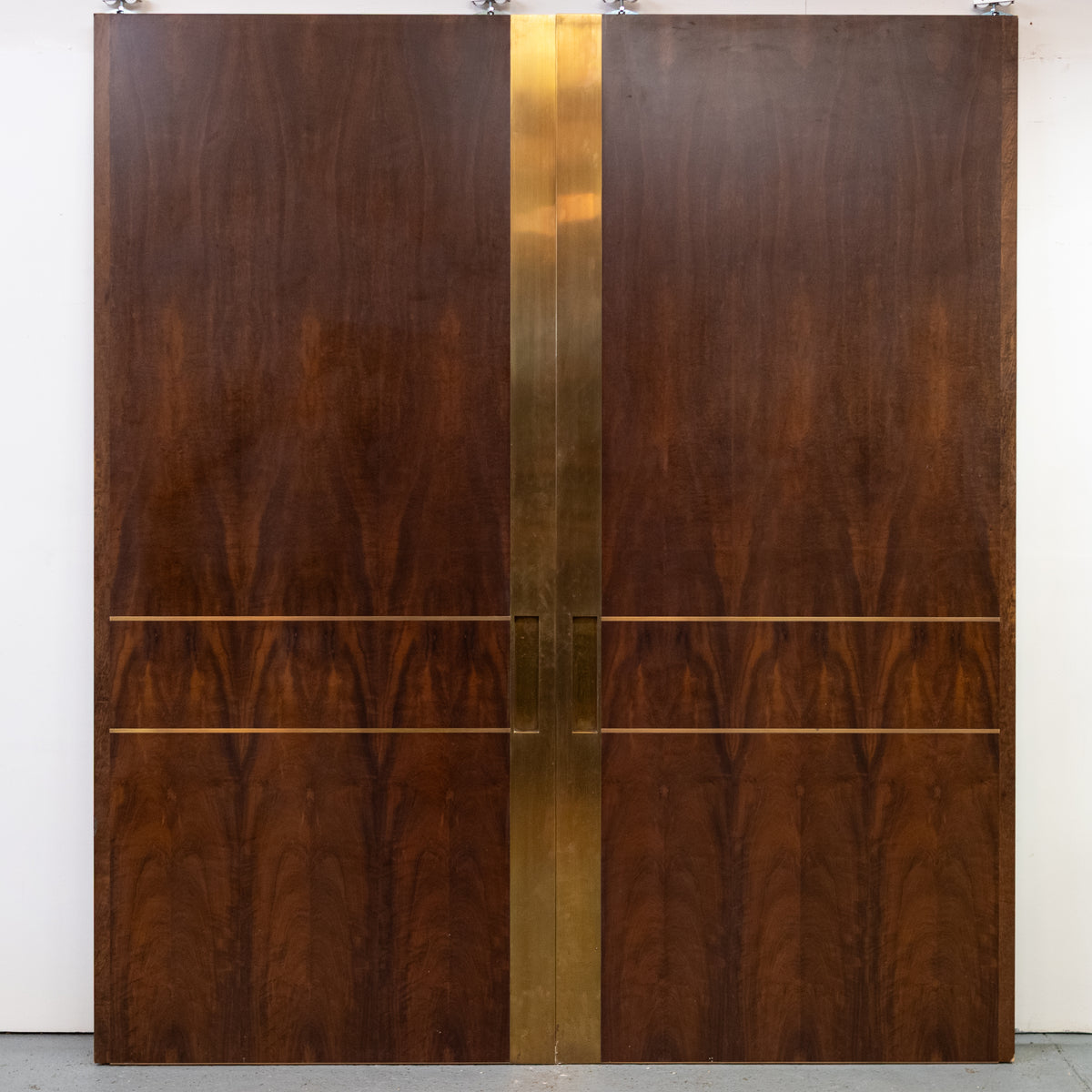 Large Bookmatched Walnut Mirrored Pocket Doors | The Architectural Forum