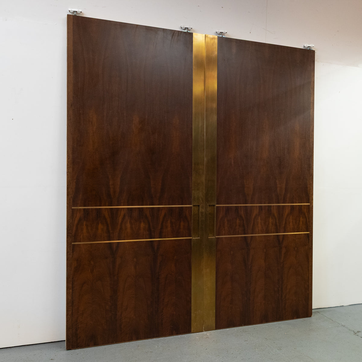 Large Bookmatched Walnut Mirrored Pocket Doors | The Architectural Forum