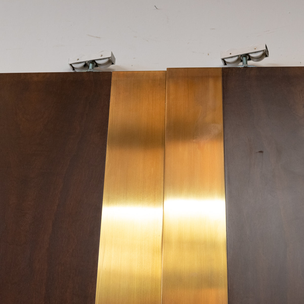 Large Bookmatched Walnut Mirrored Pocket Doors | The Architectural Forum